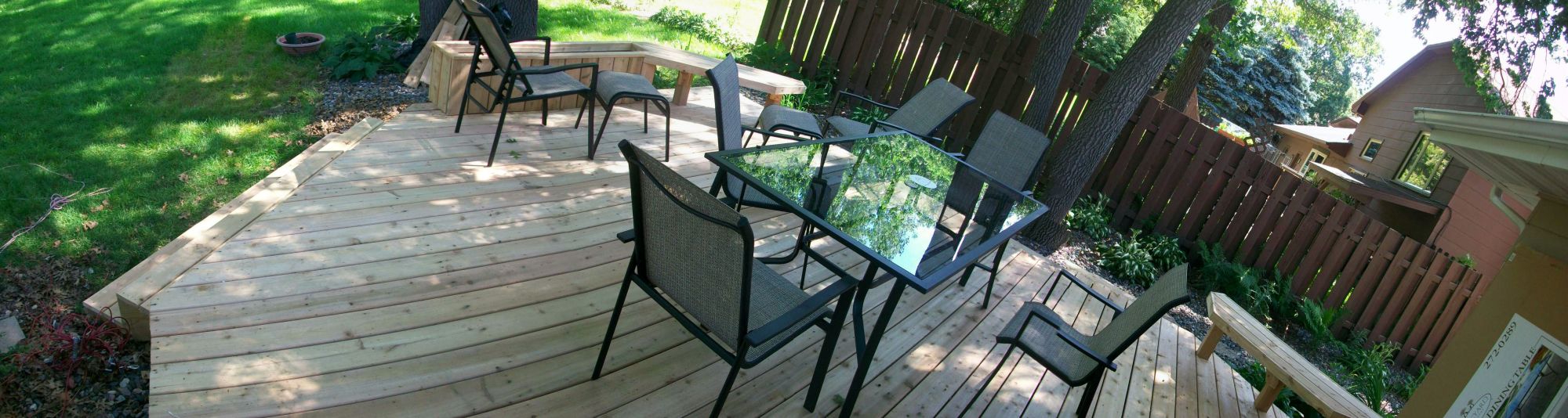 Image of a remodeled backyard patio with table and chairs